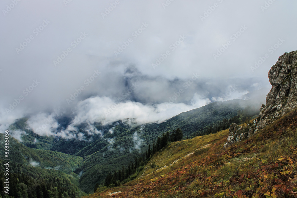 view from mountain through clouds