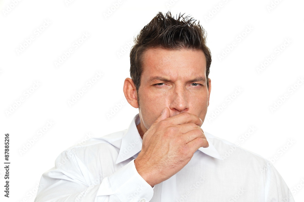 A man coughing into his hand on white background A man coughing into his hand on white background