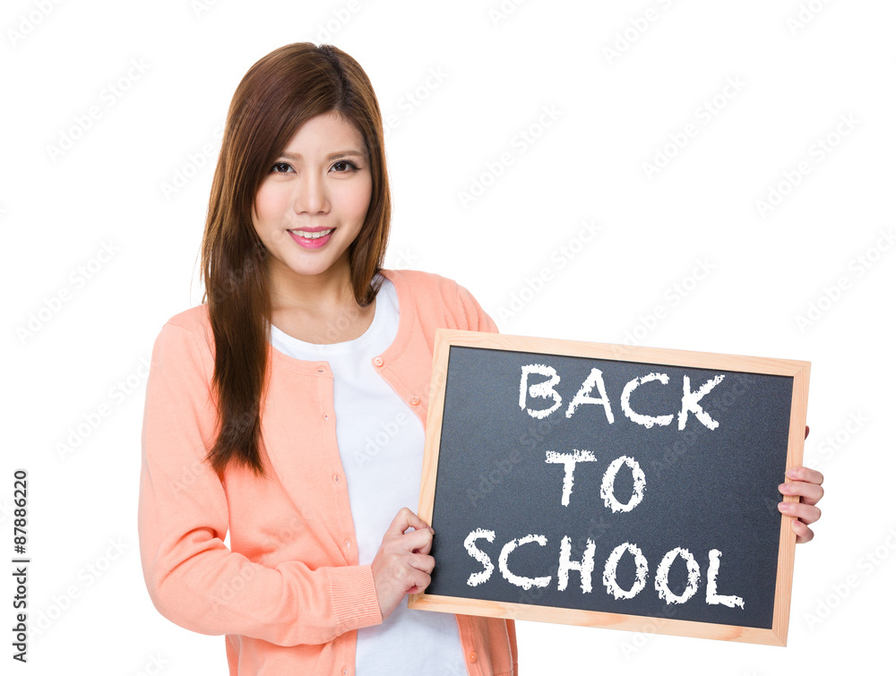 Woman hold with blackboard showing phrase of back to school Woman hold with blackboard showing phrase of back to school