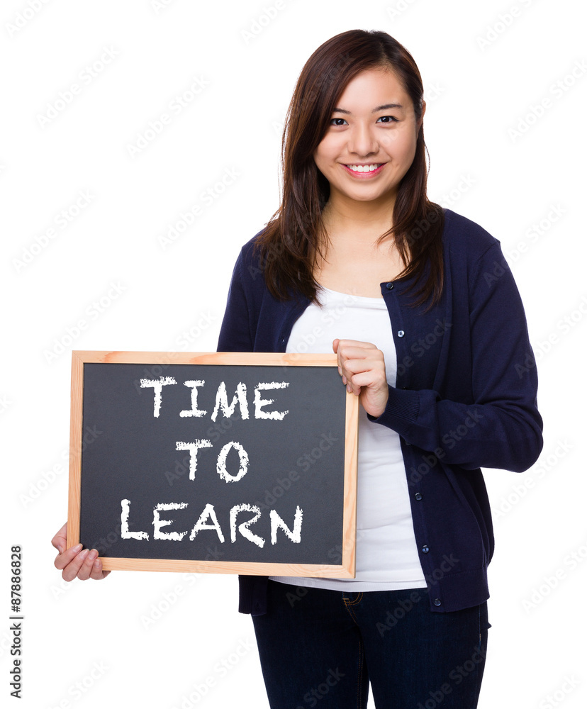 Woman showing the chalkboard with phrase of time to learn Woman showing the chalkboard with phrase of time to learn