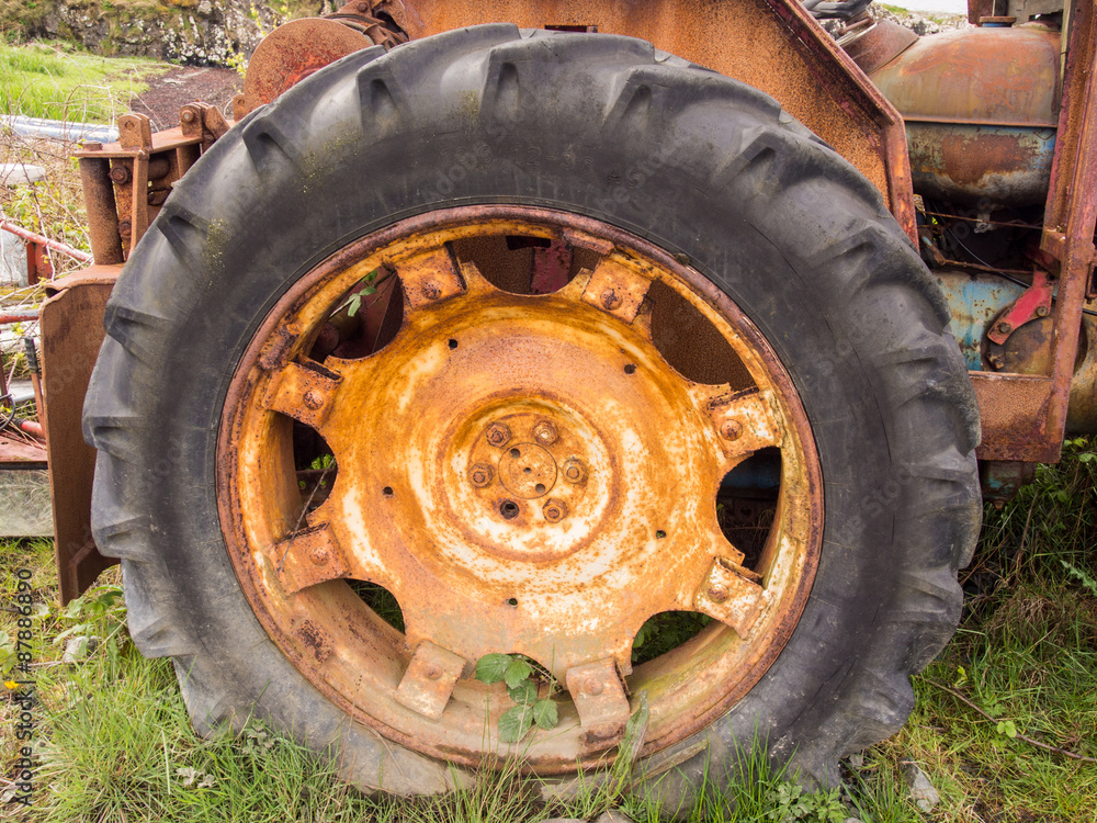 Old derelict tractor wheel and tyre, Salen Pier, Isle of Mull, Scotland Old derelict tractor wheel and tyre, Salen Pier, Isle of Mull, Scotland