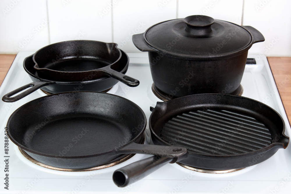 Seasoned cast iron cookware on electric stove Seasoned cast iron cookware on electric stove