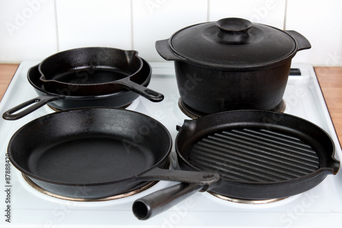Seasoned cast iron cookware on electric stove
