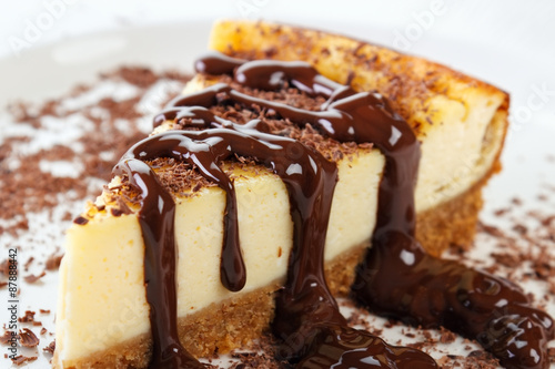 Cheesecake slice with melted and crushed chocolate photo
