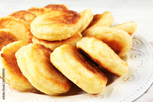 Fritters of cottage cheese in plate, closeup