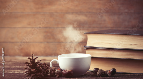 Cup of coffee and pine cone with books