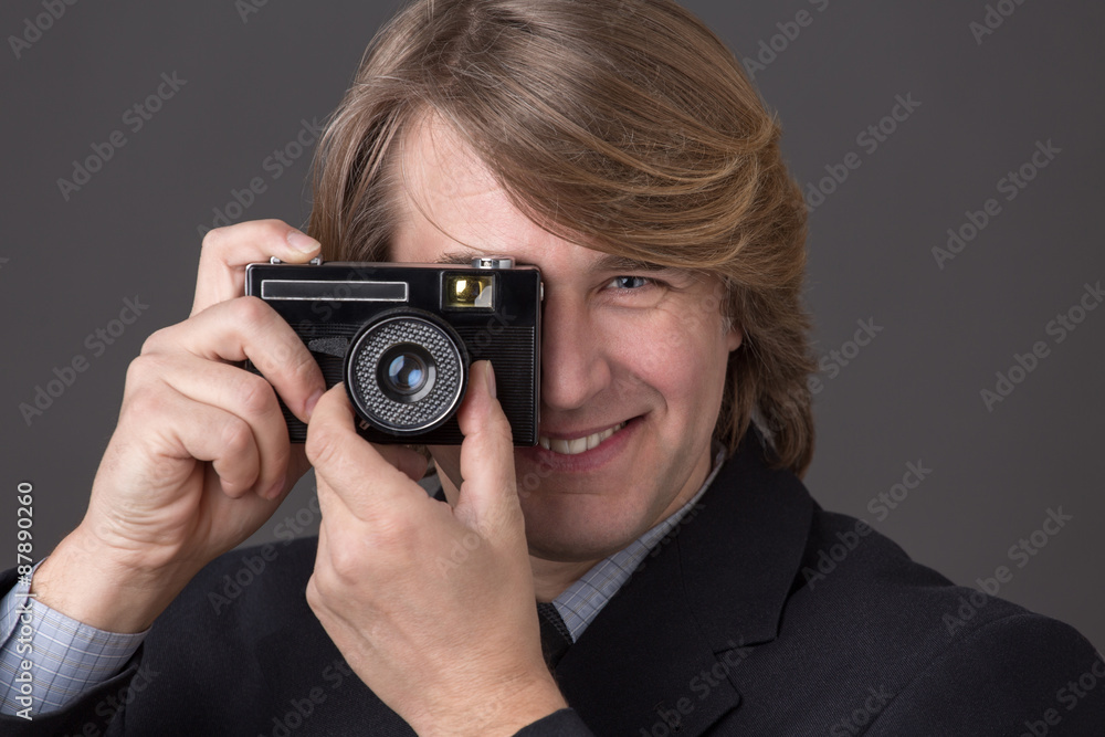 Businessman with photocamera Businessman with photocamera