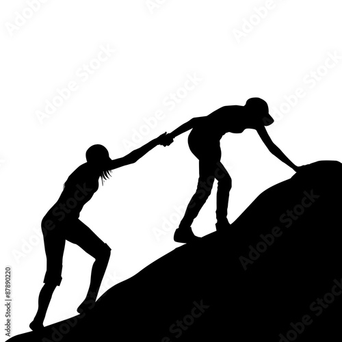 Girl giving helping hand to her friend to climb up the last sect