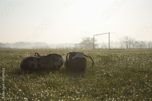 football boots on a empty football pitch