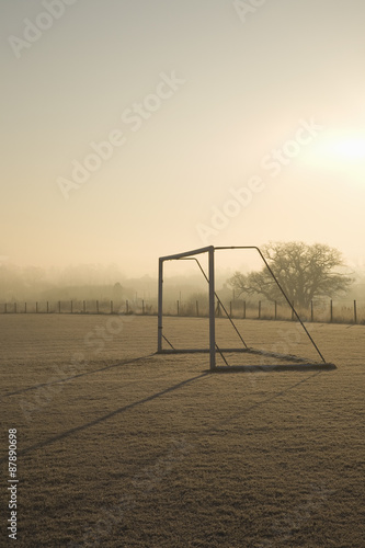 empty football pitch and goal on a frosty winter morning sunrise