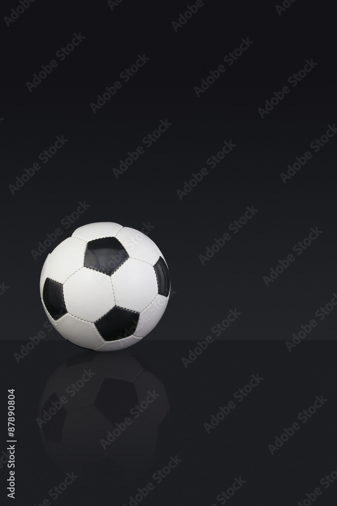 Black and white leather Football on a dark background