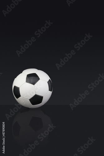 Black and white leather Football on a dark background © jasoncoxphotography