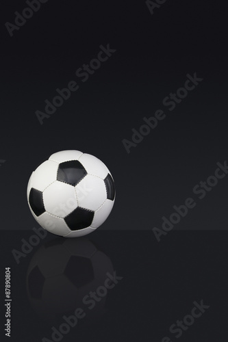 Black and white leather Football on a dark background