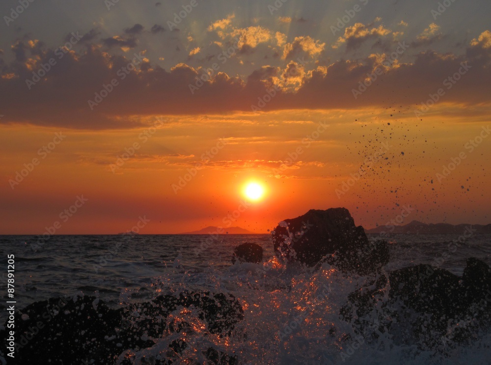 Sunset over the sea splash