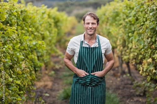Happy vintner with hands in pockets