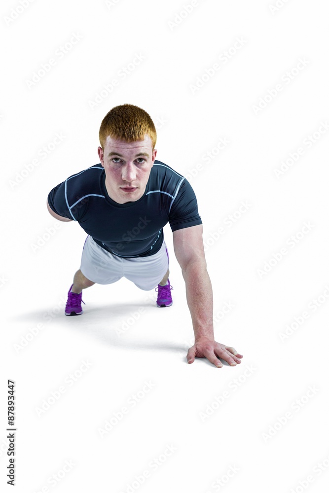 Muscular rugby player doing one hand push ups