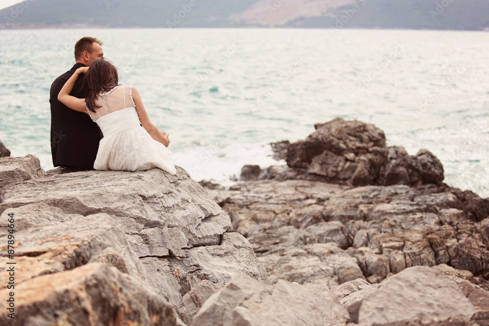 Bride and groom embracing at the beach Bride and groom embracing at the beach