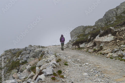 Young woman on a rocky mountain road 
