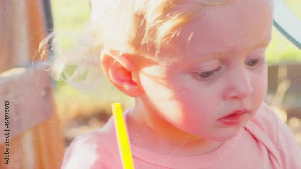 Cute blonde toddler outside in the sun Cute blonde toddler outside in the sun