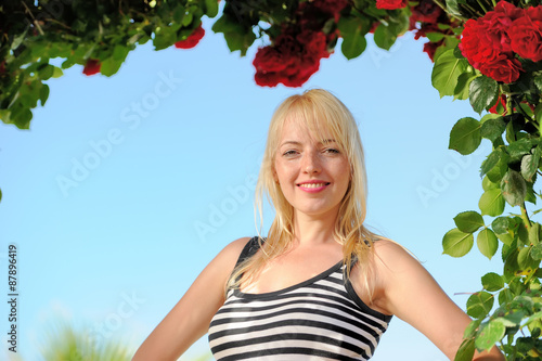 Beauty girl with roses arch