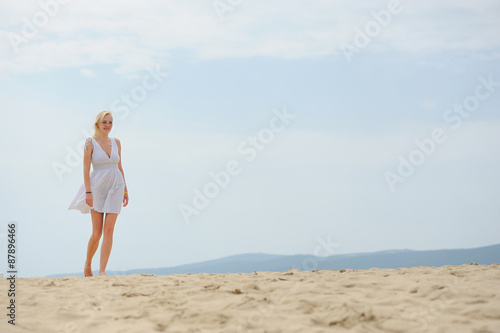 Woman on the beach in white dress © byrdyak