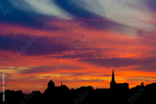 church on a orange sky.   Church against sunset © EwaStudio