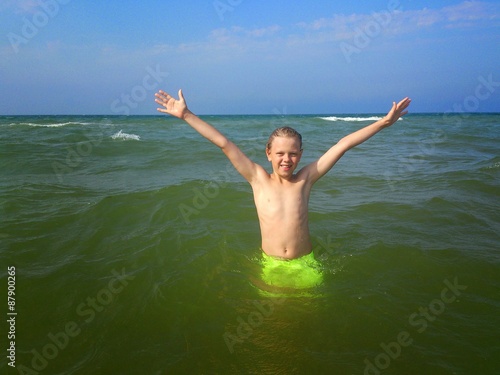 Boy swims in the sea