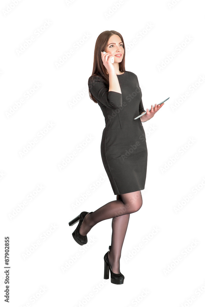 girl talking on the phone and holding in the hands of the tablet girl talking on the phone and holding in the hands of the tablet