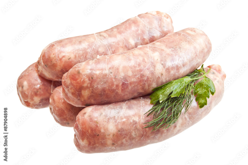 Raw meat sausages with greens isolated on white background