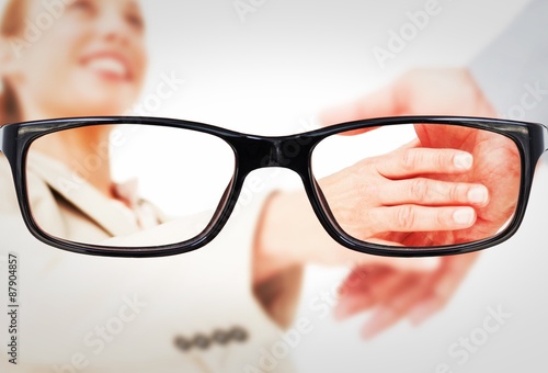 Composite image of low angleshot of a woman shaking hands photo