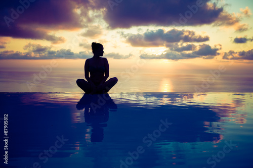 Woman sitting on the edge of the pool