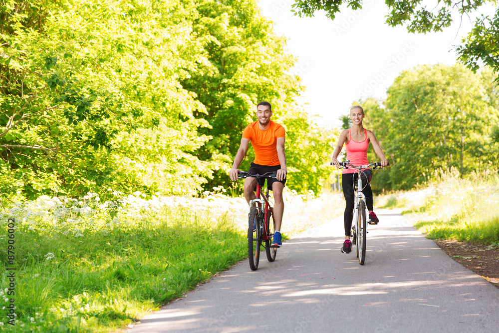 happy couple riding bicycle outdoors happy couple riding bicycle outdoors