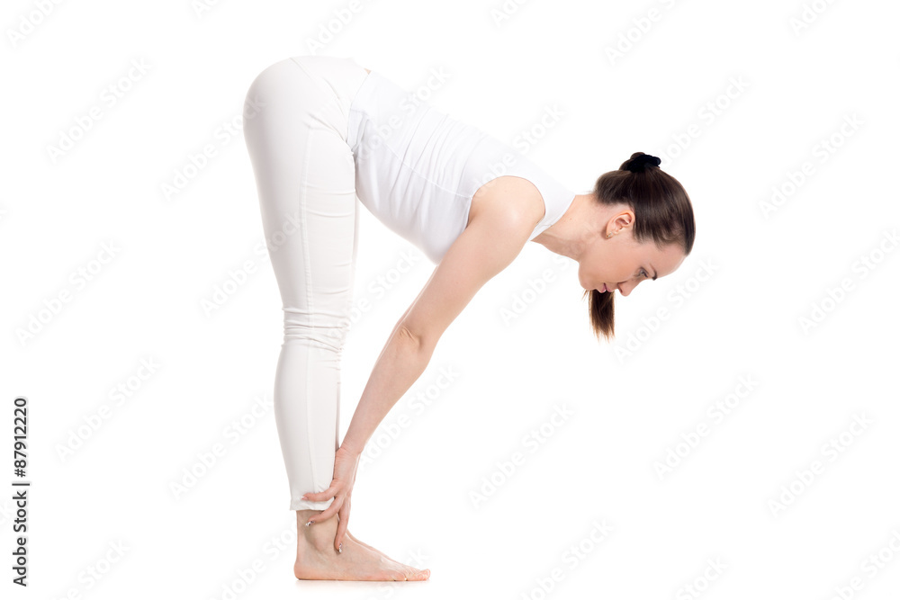 Yogi female standing in Half Forward Bend asana Yogi female standing in Half Forward Bend asana