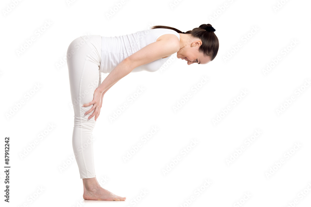 Yogi female standing in Half Forward Bend asana Yogi female standing in Half Forward Bend asana