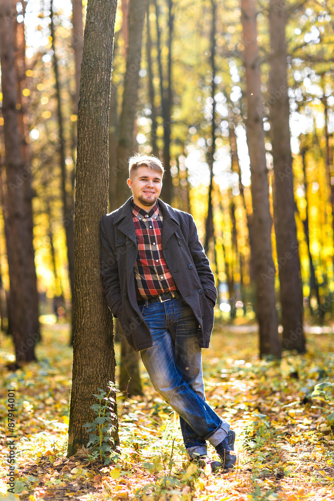  man wearing a coat in the autumn park