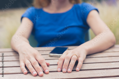 Young woman using her smart phone outside