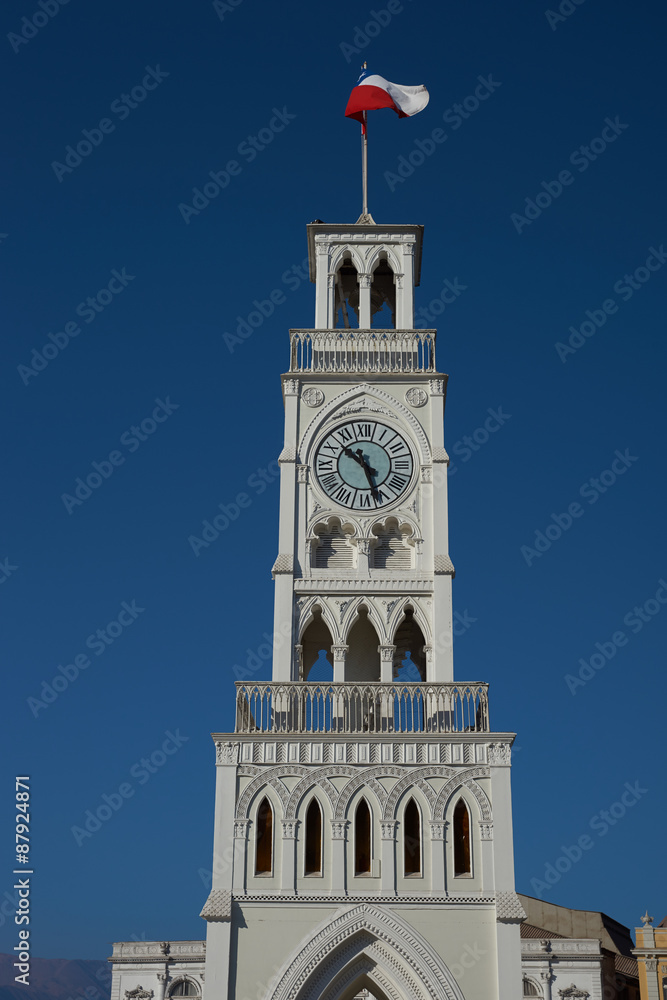 Obraz premium Historic clock tower in Plaza Arturo Prat in the old quarter of Iquique on the Pacific coast of northern Chile. Built circa 1877.