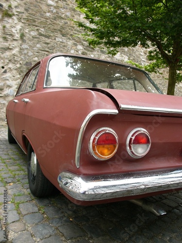 Viertürige deutsche Limousine der Sechzigerjahren vor alter Mauer in der Altstadt von Wetzlar an der Lahn im Lahn-Dill-Kreis in Hessen photo