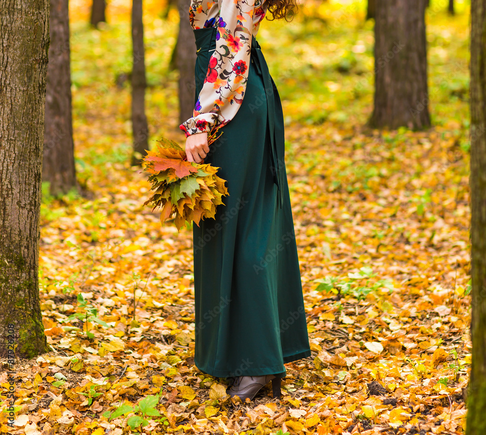 girl in autumn park with leaves