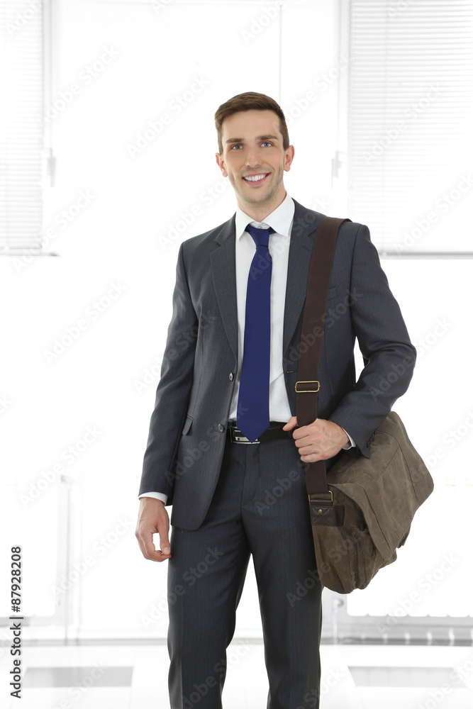 Man holding suitcase on light background Man holding suitcase on light background