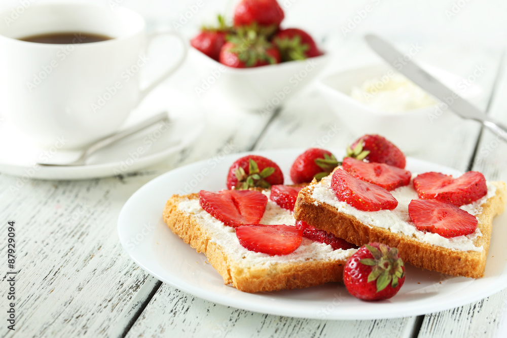 Fresh toast with strawberry on white wooden background