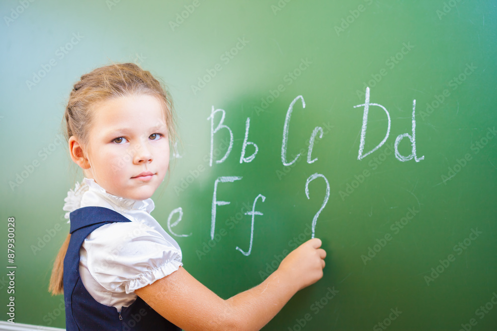 Schoolgirl wrote in chalk on blackboard and teach English language