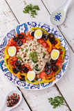 Salad with white beans and fresh vegetables,olives and egg, Turkish cuisine.selective focus