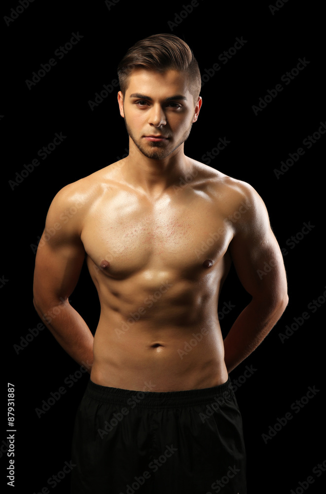 Fototapeta premium Muscle young man on dark background