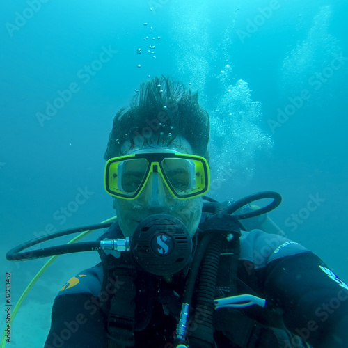 Underwater man diving scuba in Pacific Ocean