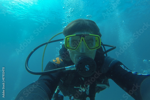 Underwater man diving scuba in Pacific Ocean
