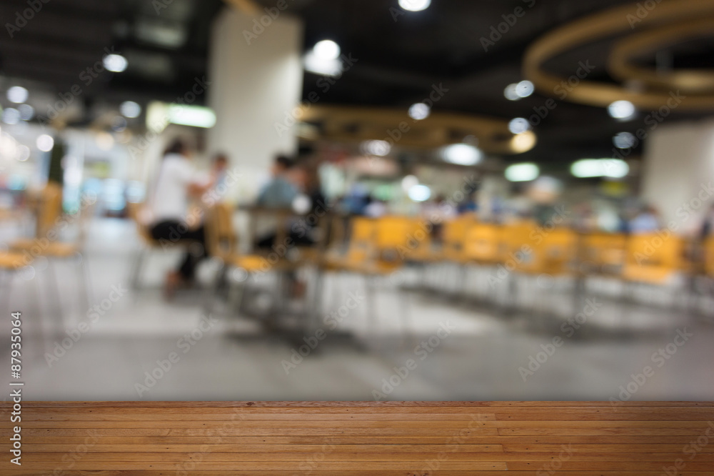 Wooden floor with  food court blurred background