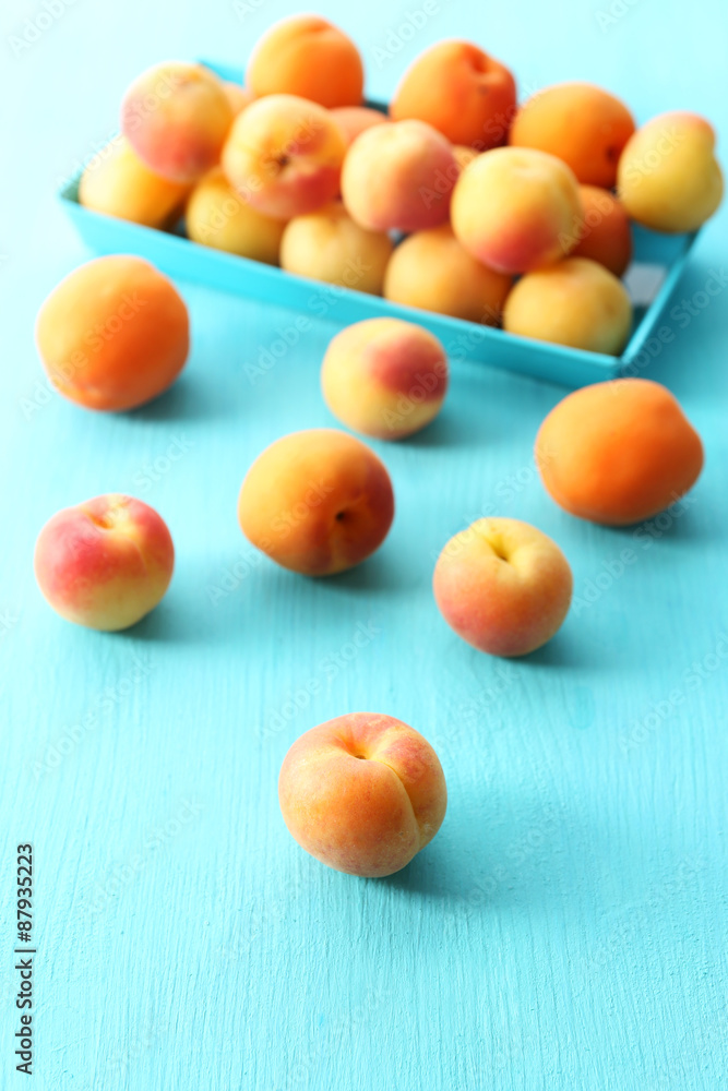 Ripe apricots on metal tray on table close up