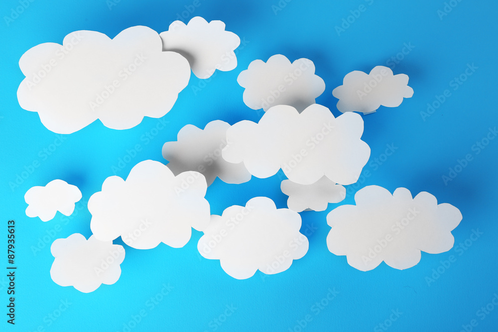 White paper clouds on blue background. Cloud computing concept. White paper clouds on blue background. Cloud computing concept.