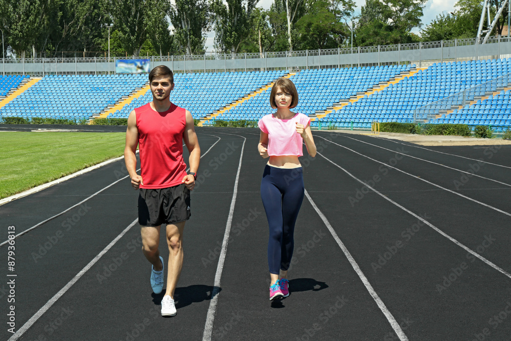 Obraz premium Young people jogging on stadium